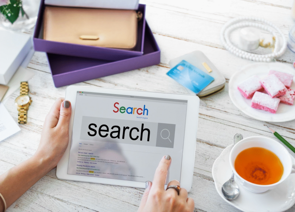 Person using a tablet to search online, representing research on the ideal meta description length for SEO.
