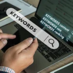 Person analyzing keywords on a laptop screen.