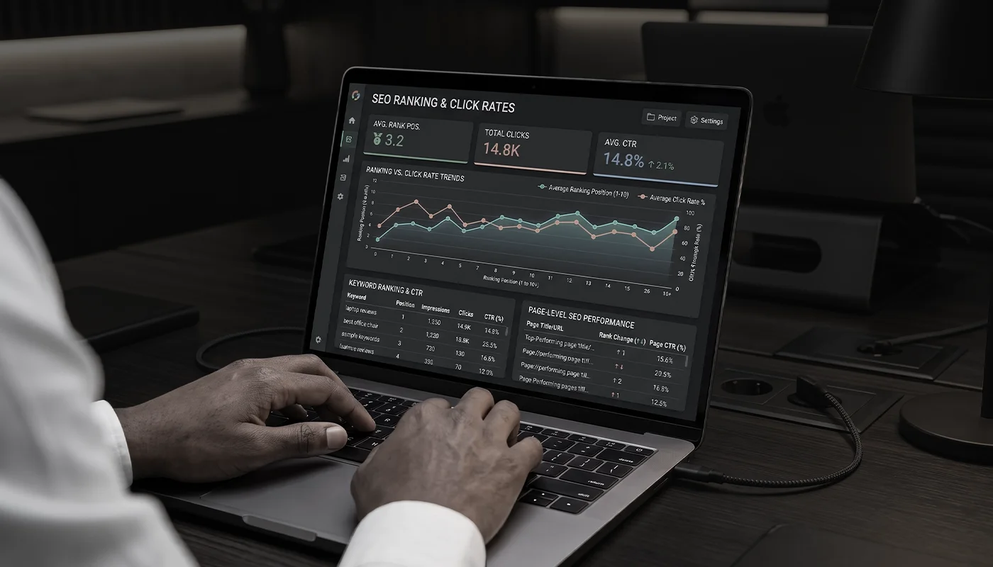 Person typing on laptop displaying SEO rankings and click rates.